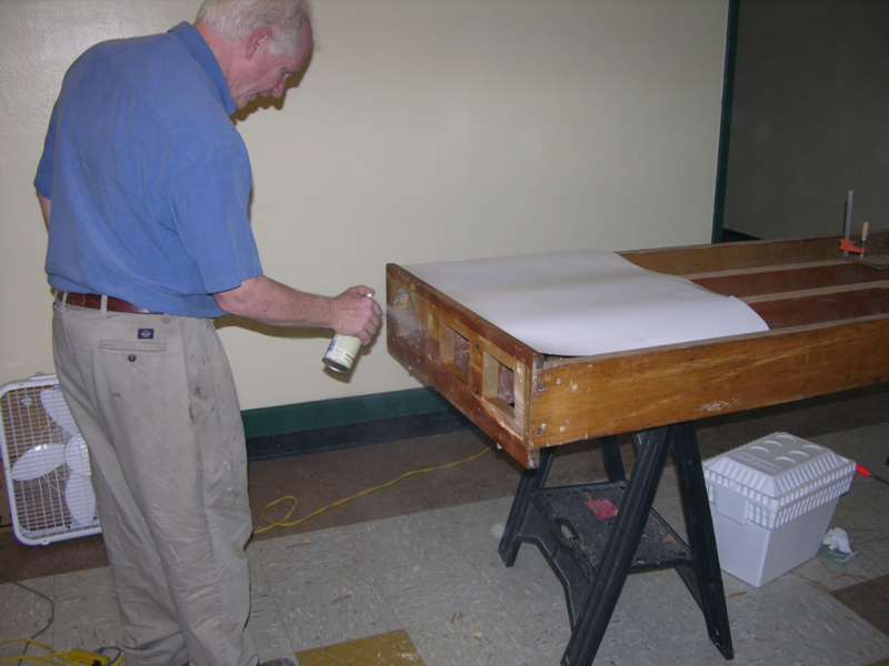 Spray shellac on the bare wood chest end