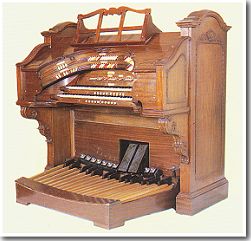 A hot-rod WurliTzer 2-Manual Theatre Pipe Organ console in natural walnut with a double stop tongue bolster.