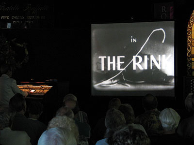 Click here to download a 640 x 480 JPG image showing Tom Hoehn accompanying The Rink starring Charlie Chaplin.