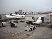 Click here to download a 2592 x 1944 JPG image shoving the gateway extended for passengers to board the aircraft at Hartsfield International Airport.