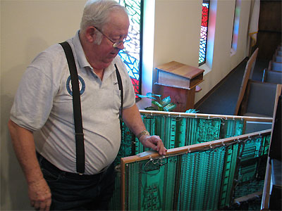 Click here to download a 2592 x 1944 JPG image showing Cyrus Roton standing at the rear of the console of the the Rodgers 755 Digital Church Organ with the two tone generator board frames swinging out.