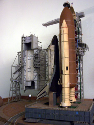 Click here to download a 1932 x 2576 JPG image of a 1/144 scale plastic model of NASA's Discovery Space Shuttle on the launch pad, built by the Bone Doctor in 1988.