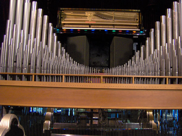 Click here to download a 2048 x 1536 JPG image looking up at the upright piano and the unenclosed classical rank above the stage.