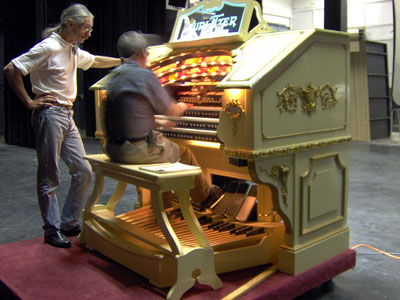 Click here to download a 2048x 1536 JPG image of the Bone Doctor standing at the console of the 3/18 Mighty WurliTzer Theatre Pipe Organ installed at Lake Brantley High School in Orlando, Florida as Tom gives her a go, too fast for the camera!