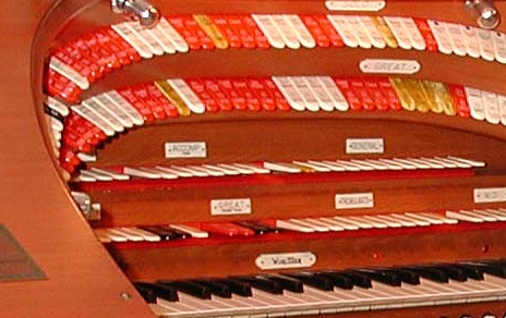 The muticolored Stop Tongues in the horseshoe of a large Theatre Pipe Organ console. Click here to see the entire console.