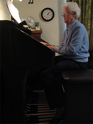 Click here to download a 1932 x 2576 JPG image showing Eleanor Winnemore at the console of her Roland Atelier Digital Residence Organ.