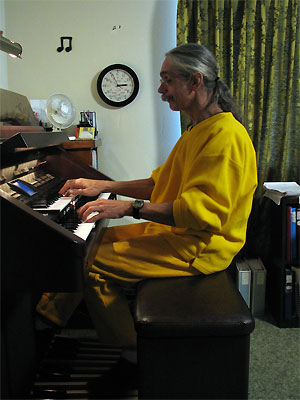 Click here to download a 1932 x 2576 JPG image showing the Bone Doctor at the console of Eleanlor Winnemore's Roland Atelier Digital Residence Organ.